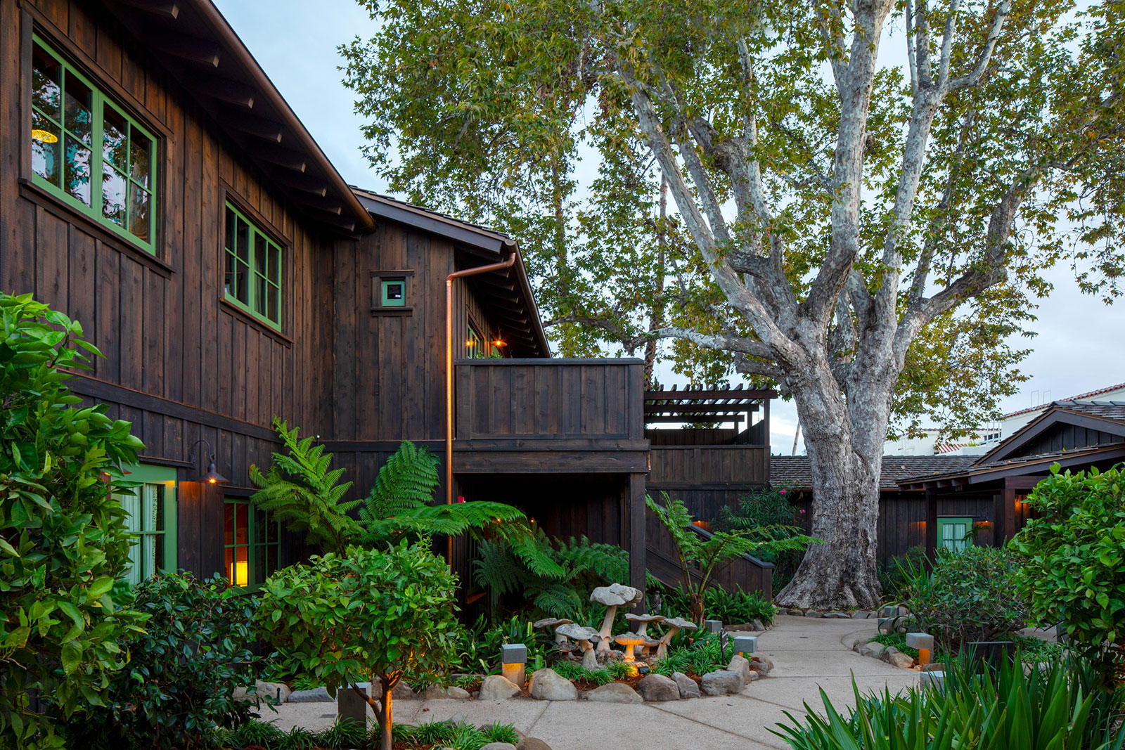 Exterior of The Sycamore House Room at Hotel El Roblar featuring a verdure lined pathway