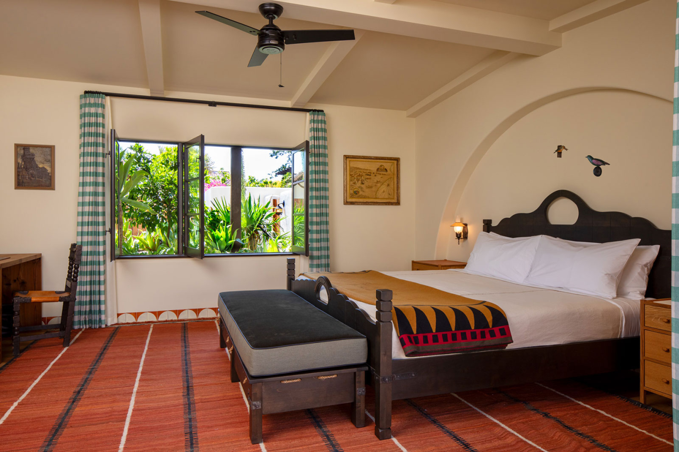 Large bed with open windows and sunshine in the Bungalow bedroom