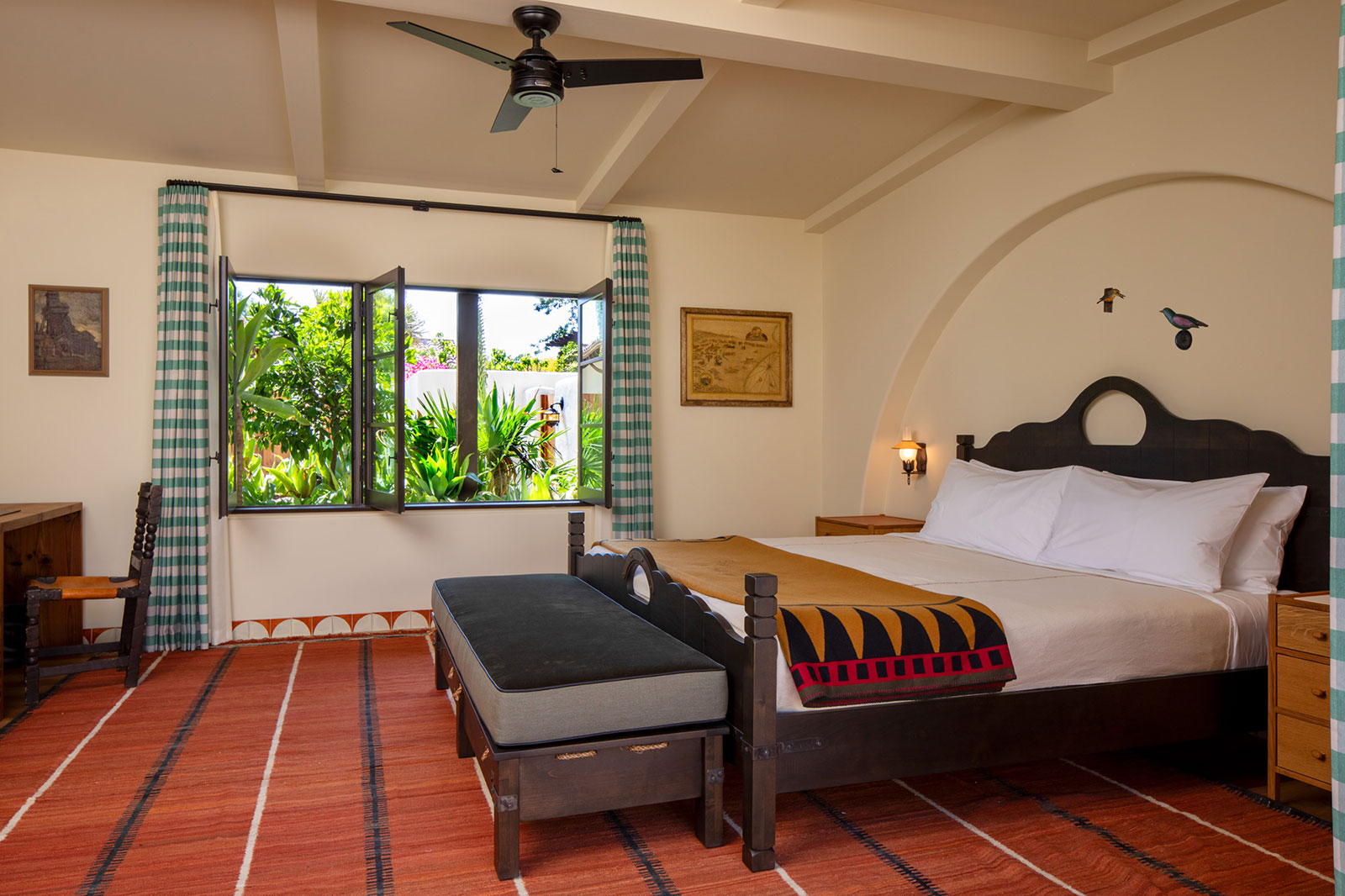 Large bed with open windows and sunshine in the Bungalow bedroom