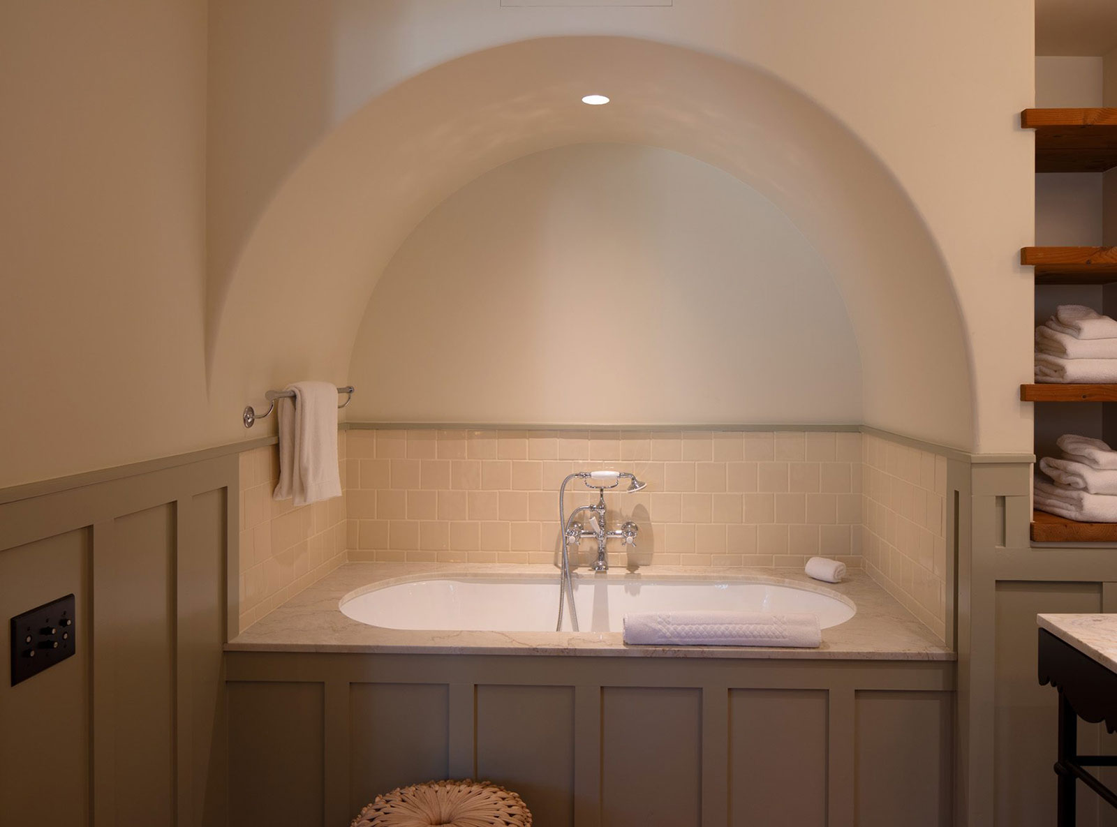 A large tub with soothing neutral colors in the Bungalow Suite bathroom