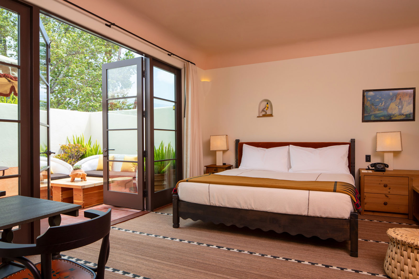 Large bed with open doors to the terrace in the King with Terrace room at Hotel El Roblar