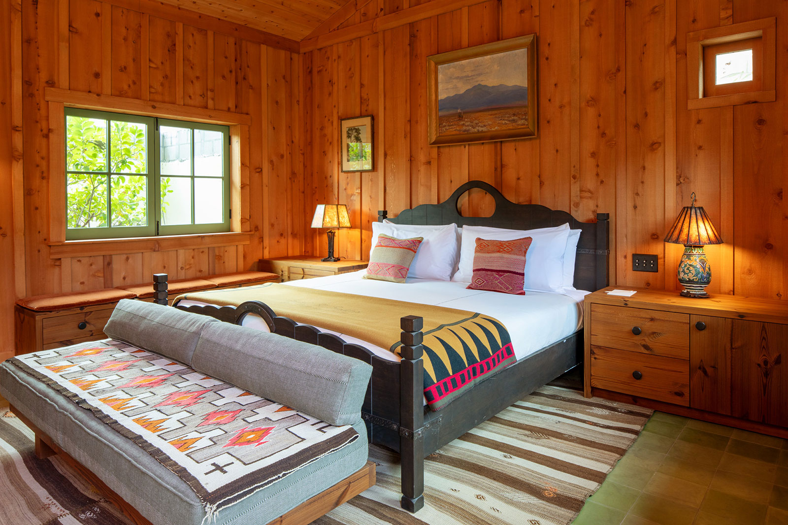 A light-filled The Sycamore House Room at Hotel El Roblar featuring a king bed with rich paneled walls